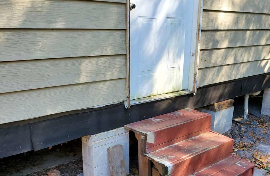 install new 15lbs felt barrier to bottom of wall